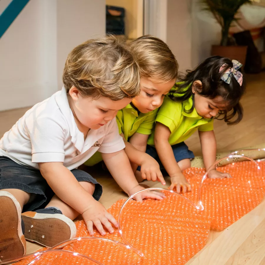 children engaged in sensory play in our daycare