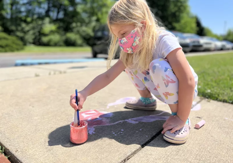 Girl painting in the street