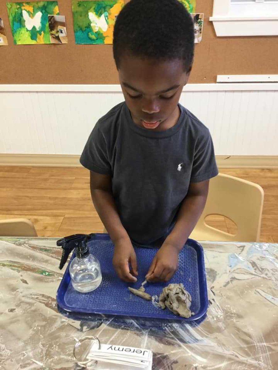 Boy being creative with clay